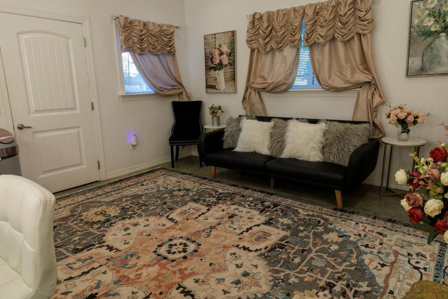 The bridal suite furnished for getting ready, with seating and mirrors.