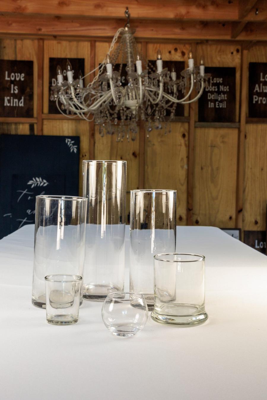 Clear glass cylinder vases in assorted sizes.
