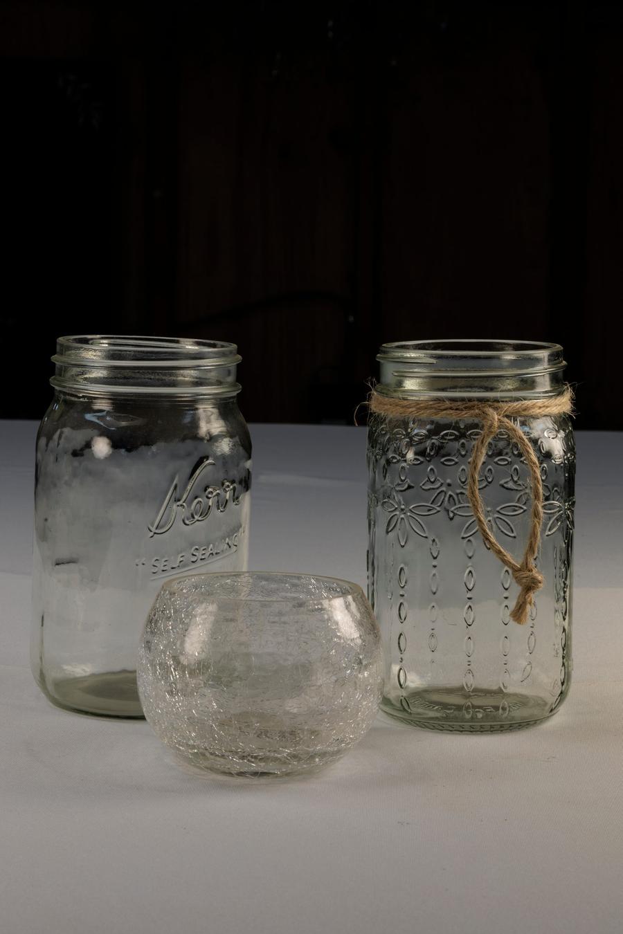 Mason jars and crackle-glass votive holders for table styling.