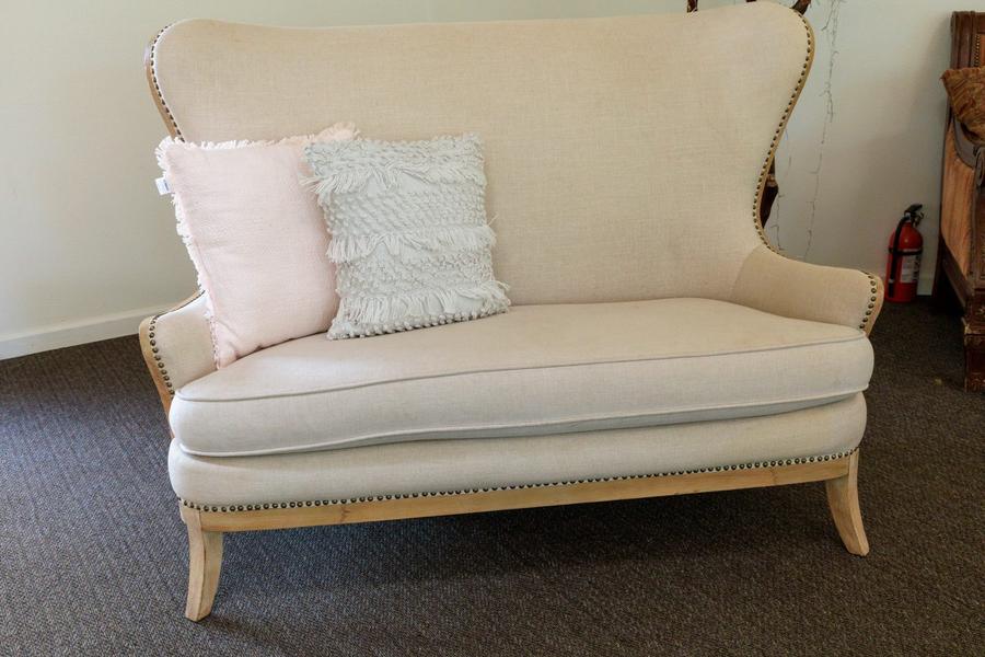 Statement couch seating for the couple, styled as a reception focal point.