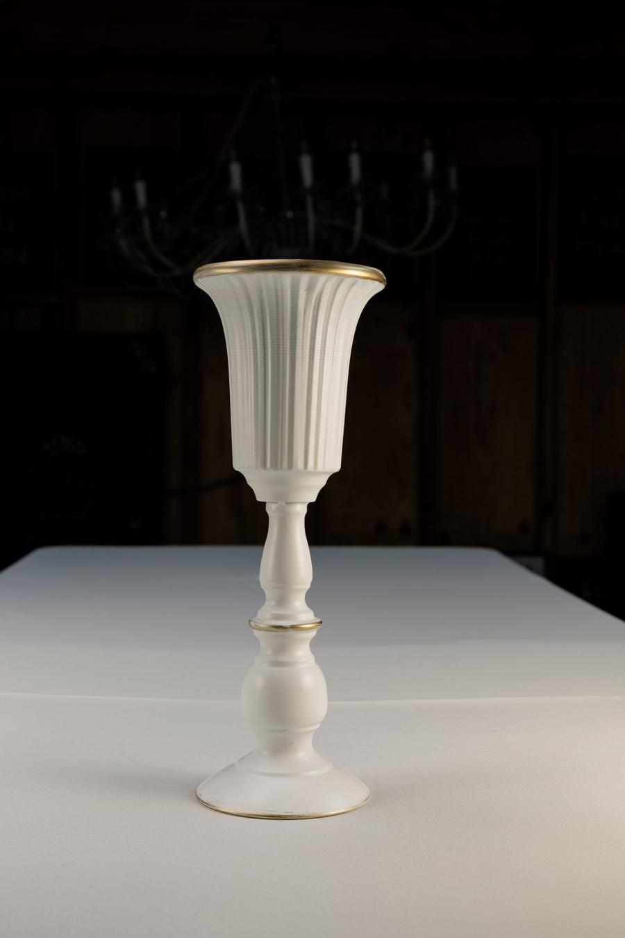 White ceramic pedestal vases with gold trim.